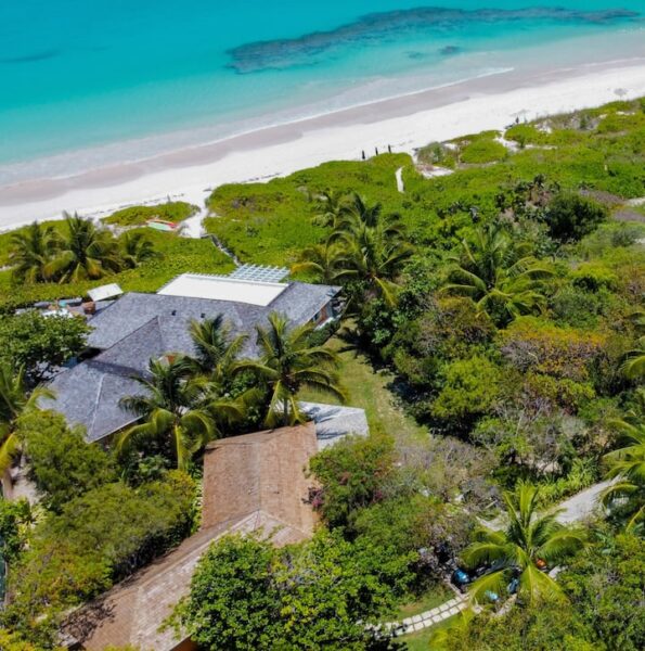 Aerial view of a beach house and trees around it