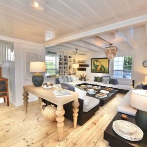 A Living Room with wooden flooring and white interiors